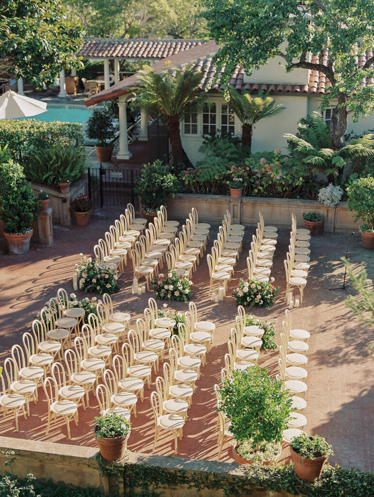Above view of ceremony space without guests. chairs are in rows with greenery surrounding.