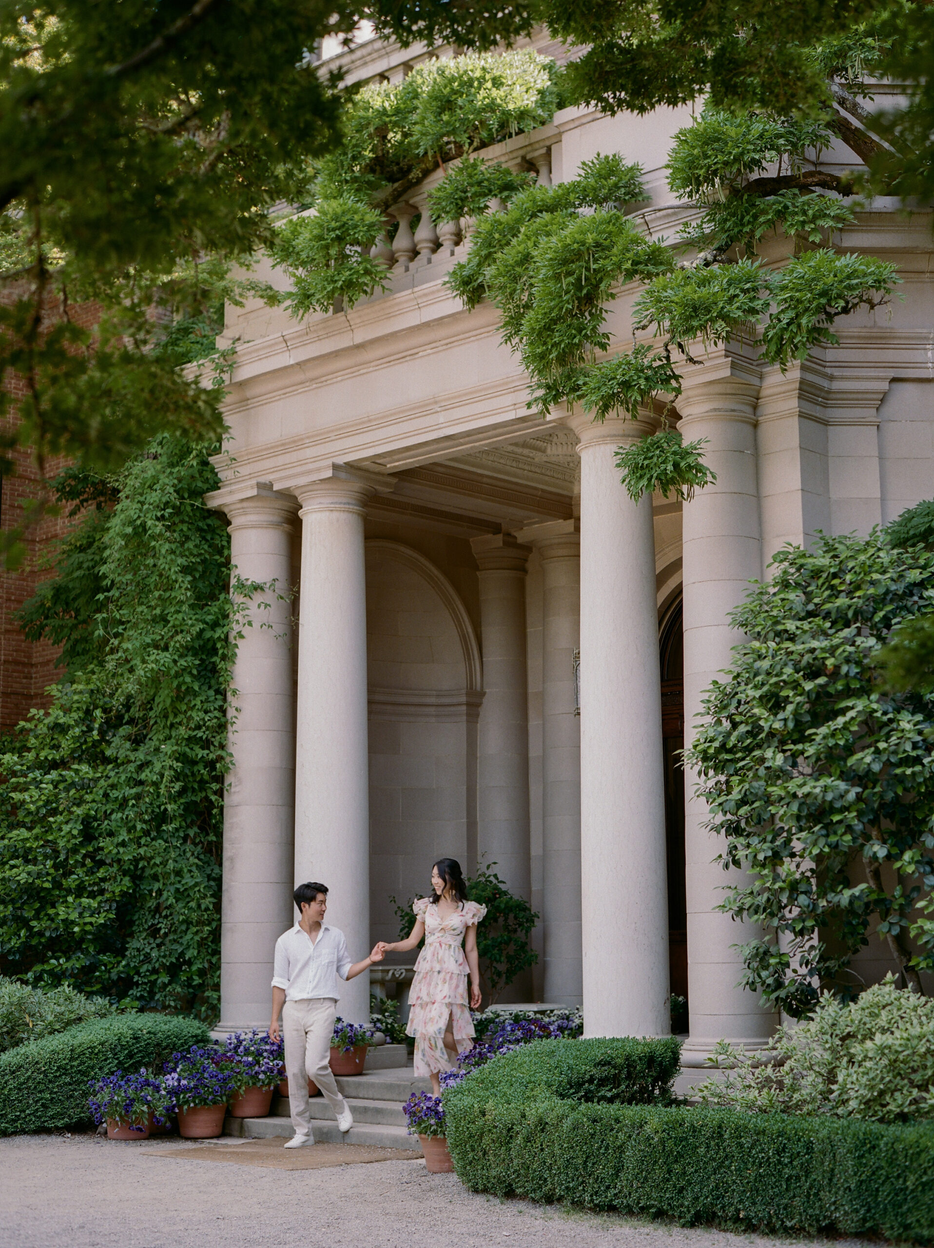 couple walking through white columns