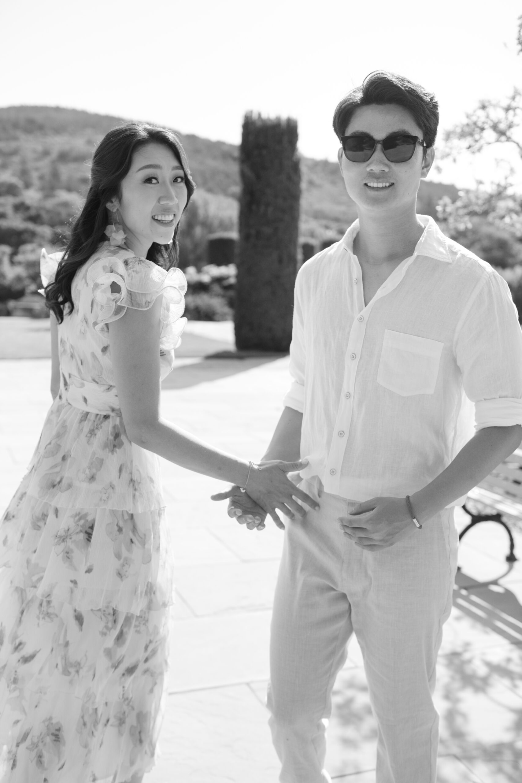 couple walking and looking back with sunglasses on