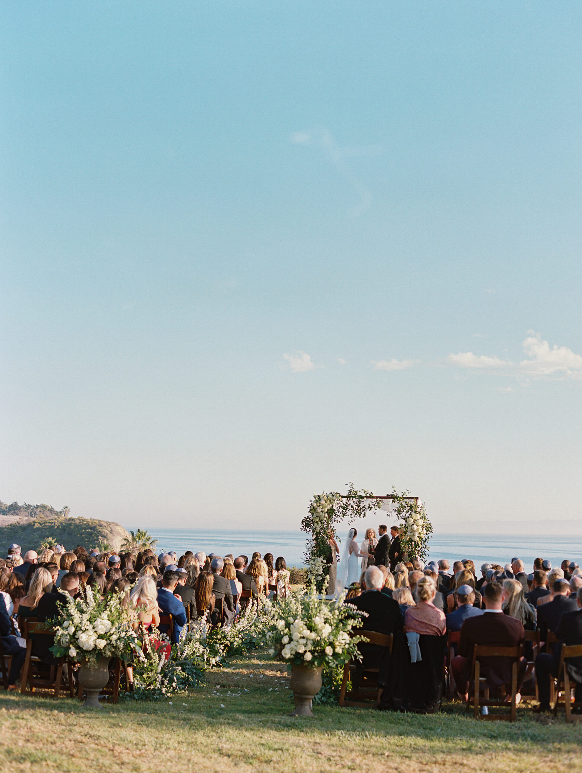 ceremony with arch on the coast of Santa Barbara. 