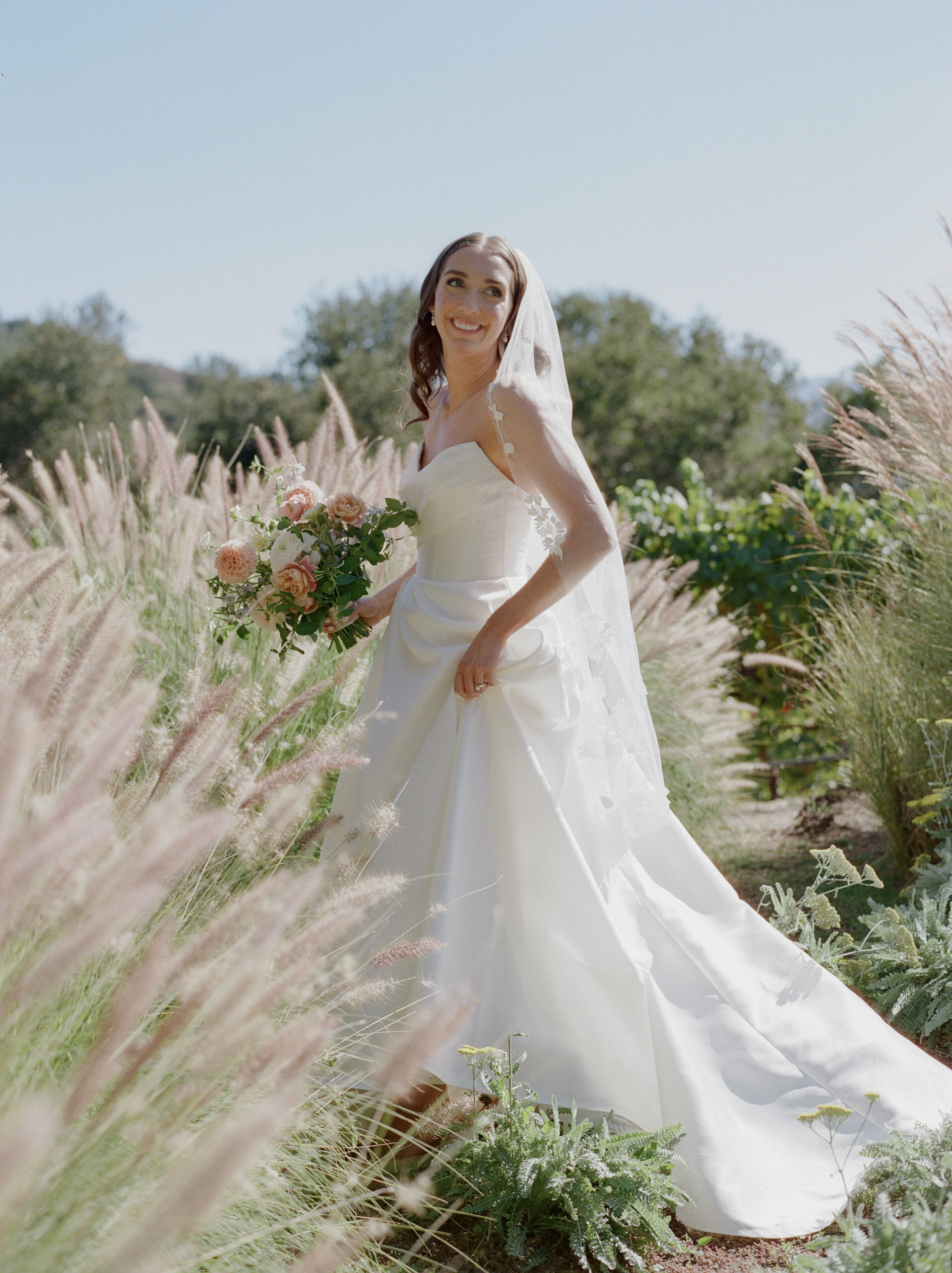 Bride walking in the tall grass in Carmel Valley, ca.