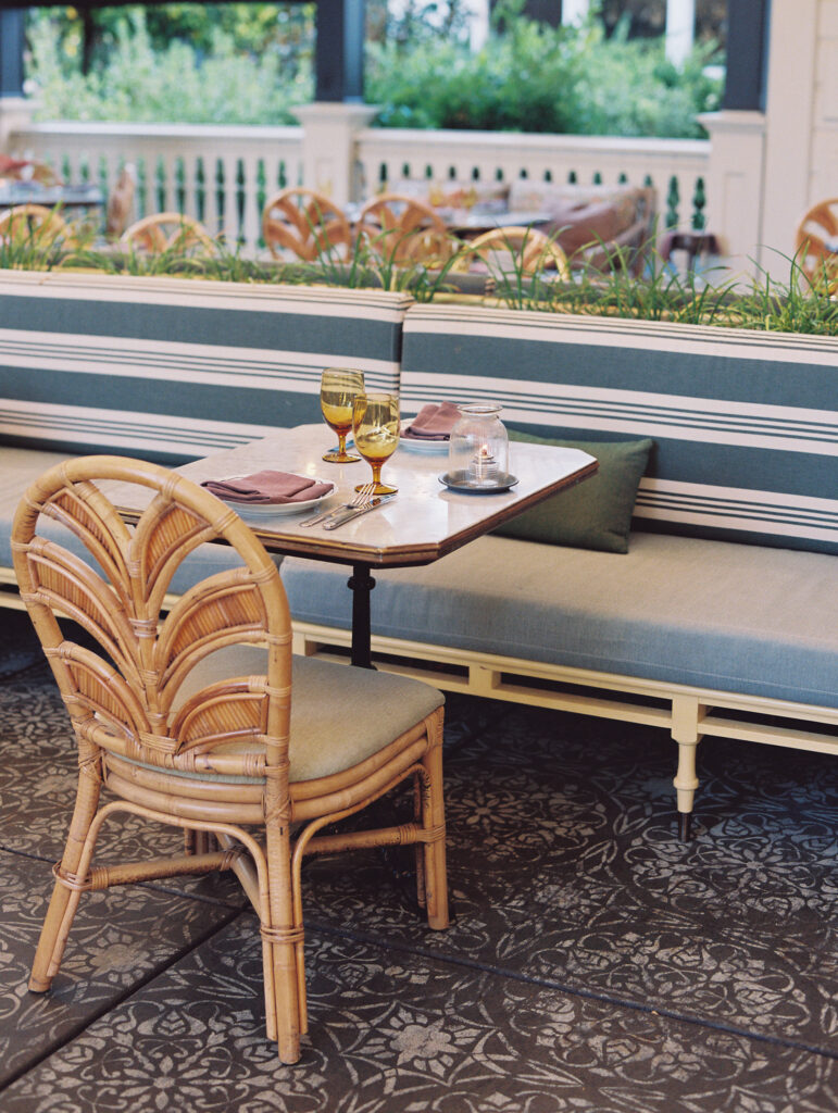 close up of wedding reception details of table and blue striped banquette seating for guests at the madrona hotel. 